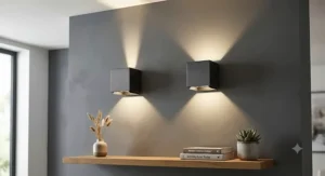 Stylish cube-shaped up and down wall lights indoor with adjustable beams on a grey painted wall.