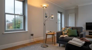 A satin chrome dimmable mother and child floor lamp with an uplighter for ambient lighting and an adjustable reading light arm.
