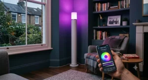 A smart colour changing uplighter floor lamp controlled by a smartphone app displaying a purple hue.