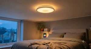 Smart LED colour changing ceiling light illuminating a master bedroom with soft ambient warm glow